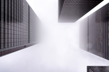 Looking up the Toronto financial district in city downtown with misty sky