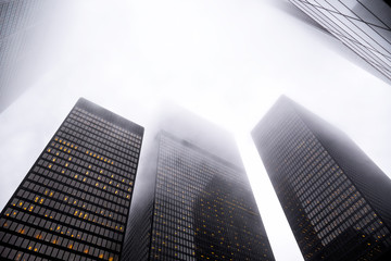 Looking up the Toronto financial district in city downtown with misty sky