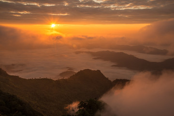 Beautiful sunrise over highland mountains view from Phu Chi Dao located in Chiang Rai province of Thailand. Winter landscape in Northern region of Thailand.