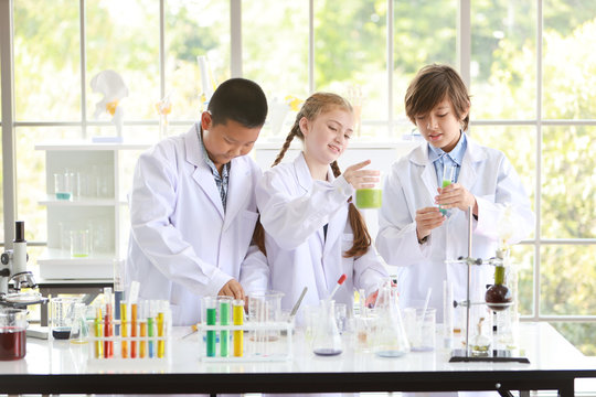 curious kid are experimenting science with attention face on colorful test tube