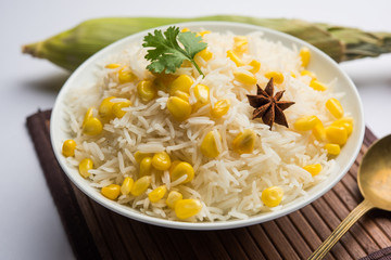 Corn Rice made using boiled Maize seeds with basmati rice, served in a bowl. selective focus 