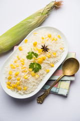Corn Rice made using boiled Maize seeds with basmati rice, served in a bowl. selective focus 