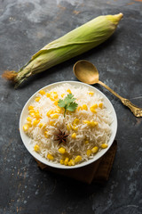 Corn Rice made using boiled Maize seeds with basmati rice, served in a bowl. selective focus 