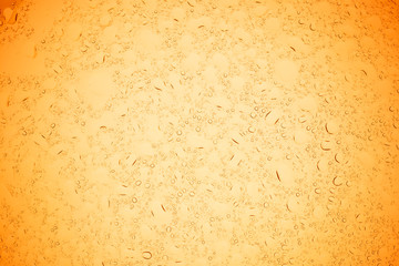 Rain droplets on yellow glass background, Water drops on yellow glass.