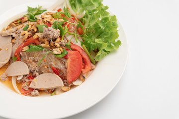 Close up Thai spicy vermicelli salad with minced pork and pork sausage on white dish