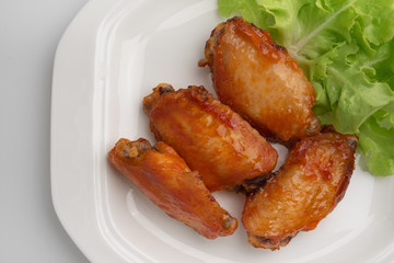 Close up deep-fried chicken wings with sweet source