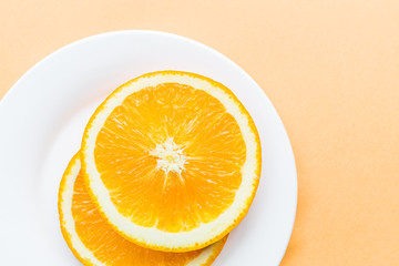 Sliced orange lying on white plate, Popular healthy fruit. Flat lay photography, Top view, overhead