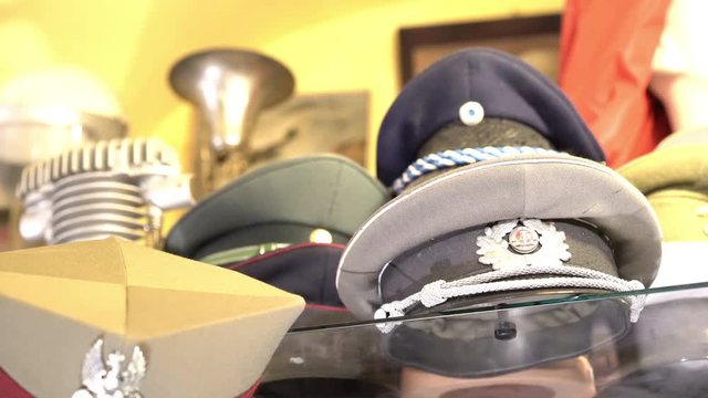 Panoramic of world war military hats and helmets in antique shop in Warsaw old town 4k