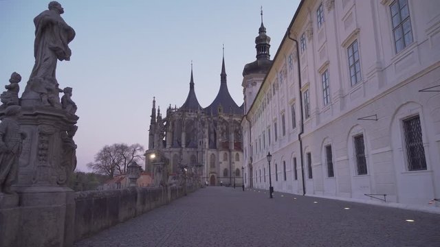 Walking towards St. Barbara's Cathedral in Kutna Hora, Czech Republic, evening shot with lights on