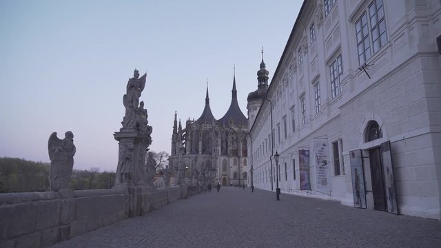 People and dog walking near St. Barbara's Church in Kutna Hora, Czech Republic, steadycam shot