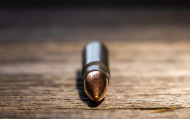 Ammunition or bullet on wood grain background. Patriotic.