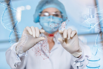 A medical worker examines a sample of blood .