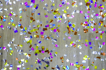 Glitteringly colorful ribbon on wooden background, Colorful confetti and ribbons background,...