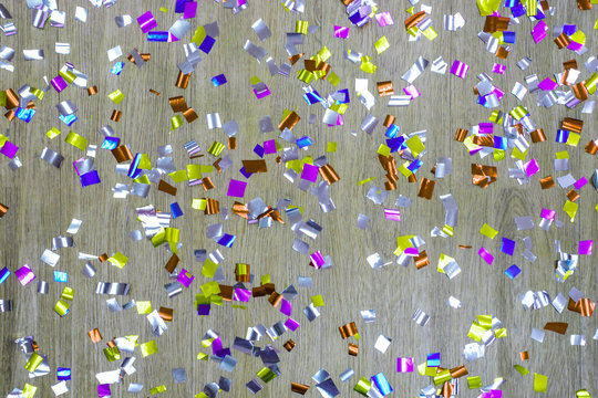 Glitteringly colorful ribbon on wooden background, Colorful confetti and ribbons background, Abstract background sparkling board for celebrity event