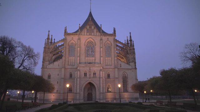 Evening shot of St. Barbara's Cathedral in Kutna Hora, Czech Republic with walking people, panning right