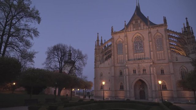 Amazing evening shot of St. Barbara's Cathedral in Kutna Hora, Czech Republic with walking people, panning left