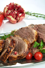 Slice of baked red meat. Beautiful serving dishes