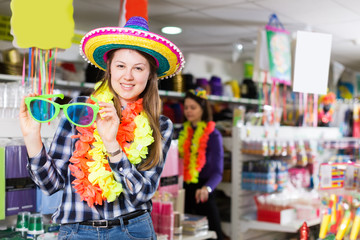  girl choosing for  things in store of festival outfits