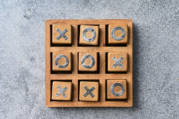 Wooden tic tac toe (O X) game. The concept of business strategy and competition 