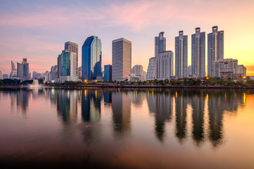 Fototapeta na wymiar Business district cityscape from a park with sunrise time, Bangkok Thailand.