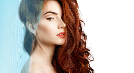 Sensual redheaded woman under water splash with fresh skin.