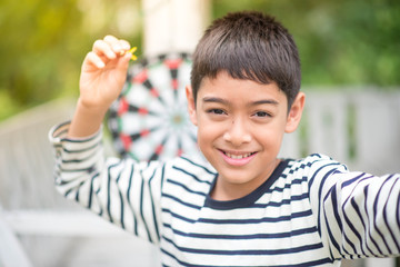 Little boy playing darts board family outdoor activity