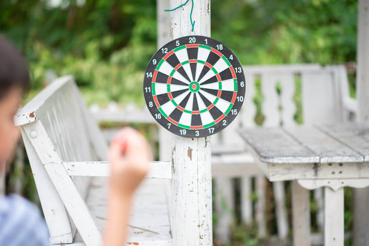 Little boy playing darts board family outdoor activity
