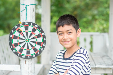 Little boy playing darts board family outdoor activity