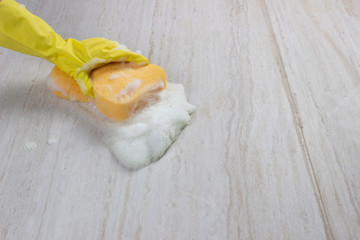 Cleaning floor with sponge ans soap