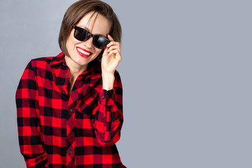 Portrait of beautiful woman wearing sunglasses, modern shirt