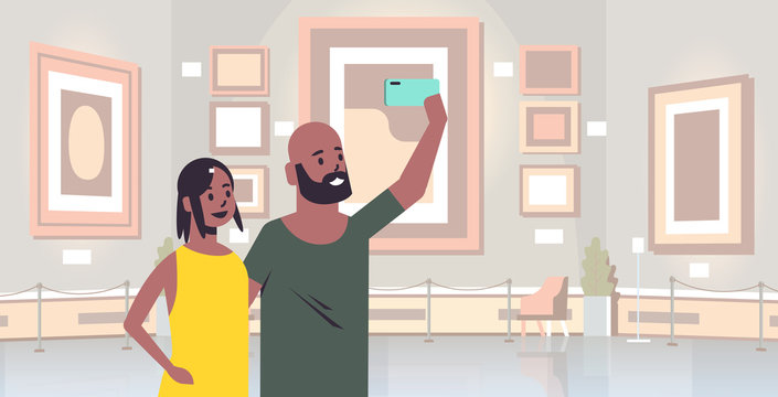 Young Couple Taking Selfie Photo On Smartphone Camera African American Man Woman Visitors In Modern Art Gallery Museum Interior Portrait Horizontal