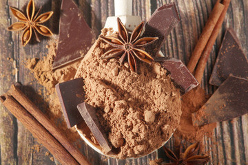 Cocoa powder and a bar of dark chocolate