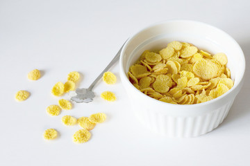 Healthy breakfast with cornflakes and milk over white background