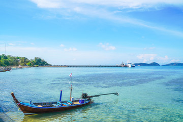 Fototapeta na wymiar boat floating on turquoise sea with bright blue sky in Phuket province, Thailand