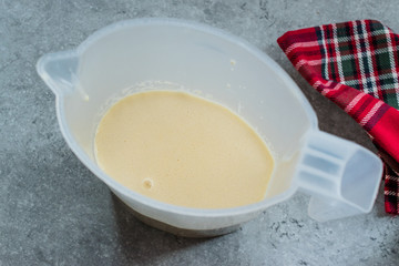 Raw Pancake Dough in Plastic Carafe Ready to Pour on Pan.