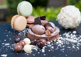 Chocolate tart slice with macaroons, chocolate chips. Selective focus