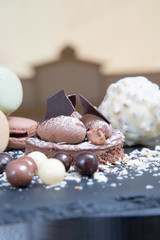 Chocolate tart slice with macaroons, chocolate chips. Selective focus