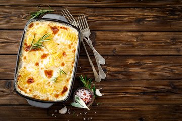 Potato gratin. Baked potato with cream, cheese and garlic