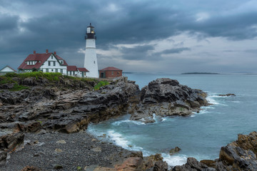 Fototapeta na wymiar Portland Head Light at stormy dramatic clouds in Maine, New England.