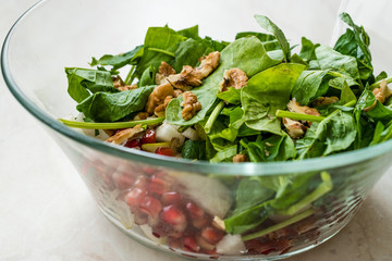 Fresh Walnut Salad with Pomegranate and Pear Slices in Glass Bowl. Ready to Make.