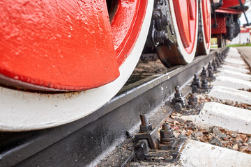 Steel wheels old steam locomotive standing on rails, vintage train, close-up