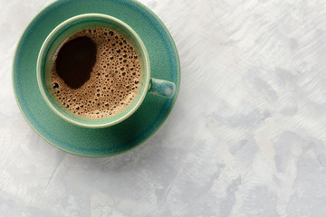 An overhead closeup photo of a cup of coffee, shot from the top with a place for text