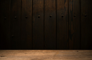 Selected focus empty brown wooden table and wall texture or old black brick wall blur background image. for your photomontage or product display