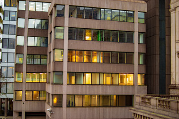 The yellow building with lights in london with glass windows