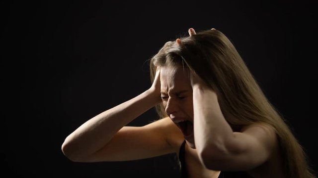 Frustrated woman holding head and screaming, mental disorder, depression
