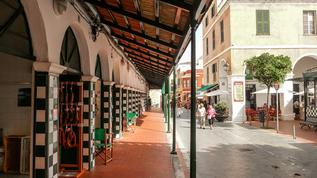 View from the street of the city market of Ciutadella de Menorca, with arches and walls decorated with checkered majolica features