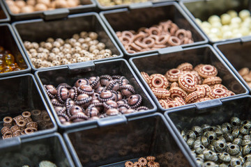 pearl beads in different boxes. Material for handmade jewelery. Background for the store and the master. Shop for creativity. Fashionable craft of women.