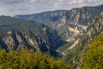Naklejka premium The mountains and the river Kalarrytikos (Greece)on a sunny summer day.