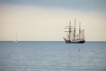 Fototapeta na wymiar Big tourist ship and small yach on water landscape