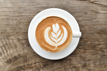 Coffee cup with latte art foam on wood table in coffee shop with copy space.Coffee is one of the most popular beverages.Improve Energy Levels and Burn Fat